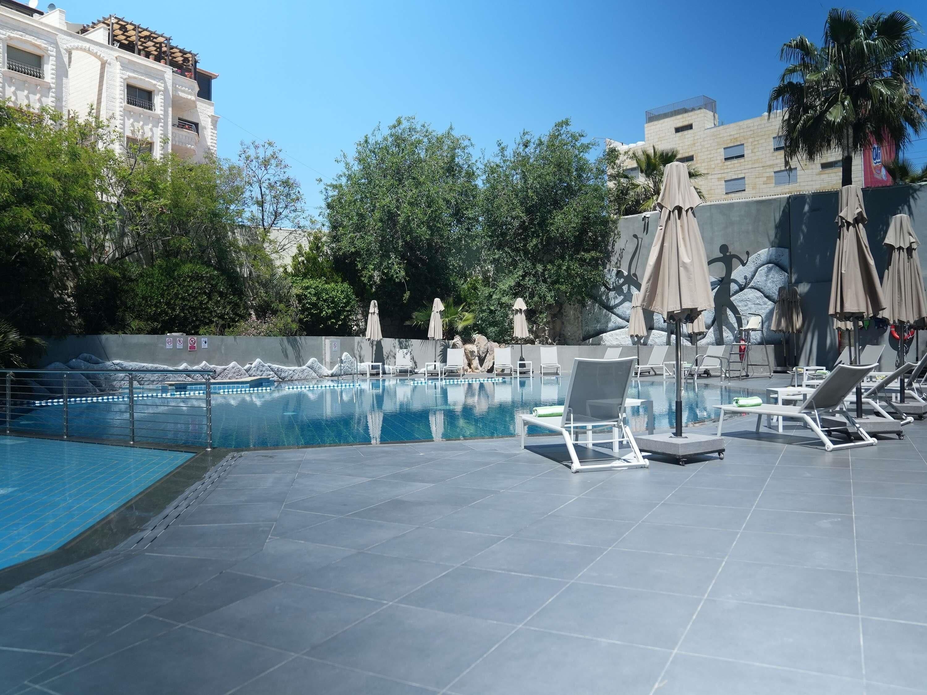 Seasonal outdoor pool, open 9:00 AM to 6:00 PM, pool umbrellas