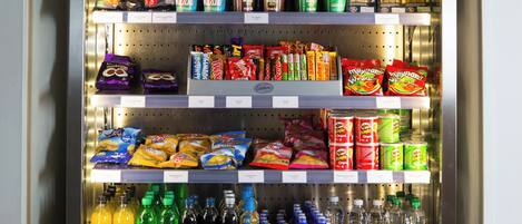 A refrigerated display case stocked with various food items and beverages.