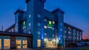 A Holiday Inn Express hotel with a modern design, featuring a prominent entrance and a parking area. - Holiday Inn Express Oxford-Kassam Stadium by IHG (Oxford)