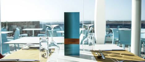 A table set for dining with clear glassware and a menu stand.