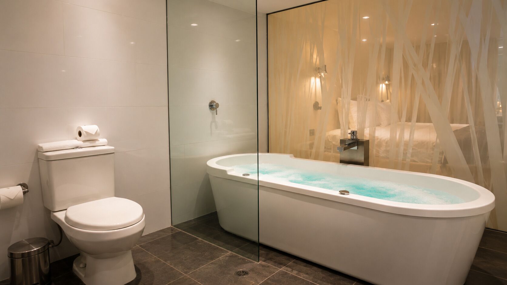 Un baño moderno con inodoro, bañera y cabina de ducha de vidrio.