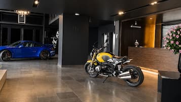 Un espacio de exhibición con una motocicleta BMW y un coche deportivo azul.