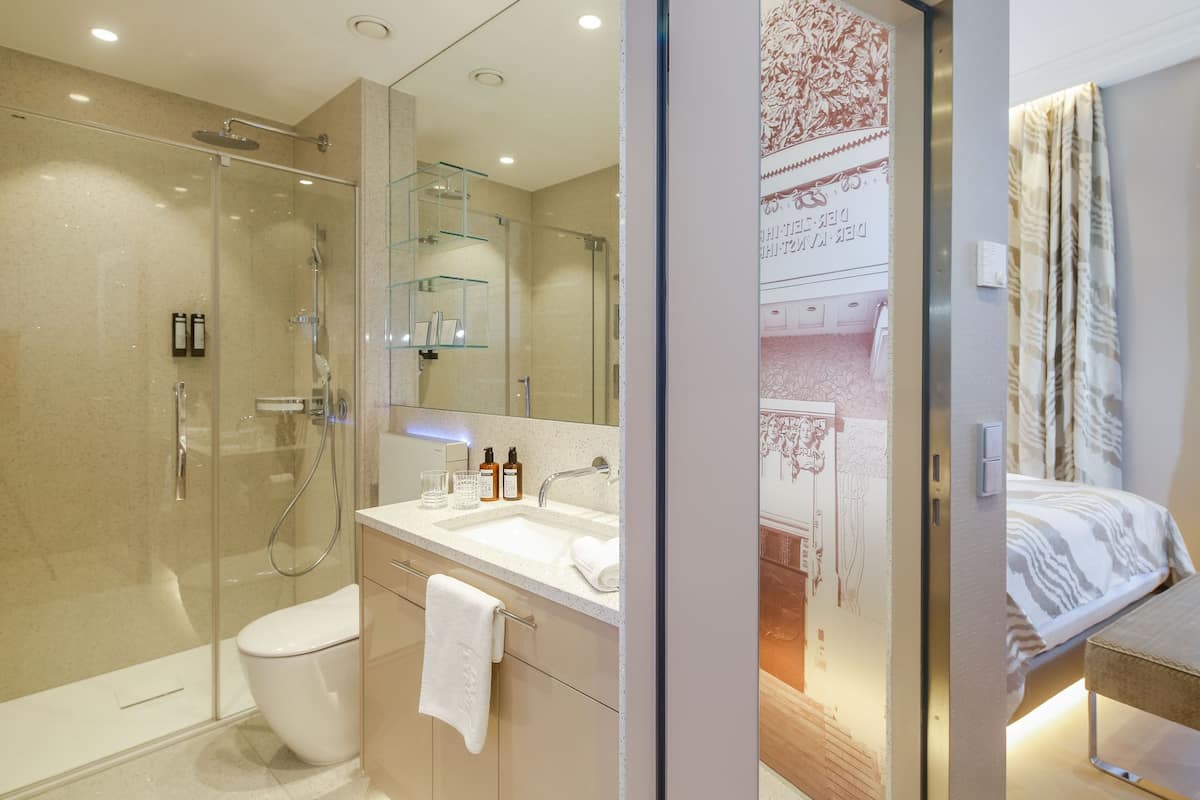 superior double room | bathroom | rainfall showerhead, designer toiletries, hair dryer, bathrobes