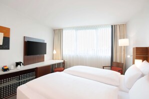 Relax in comfort with a large bed, flat-screen TV, and a convenient desk area.