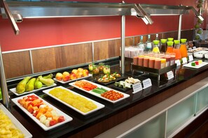 Indulge in a diverse spread of fresh fruits, vegetables, and juices at our buffet.