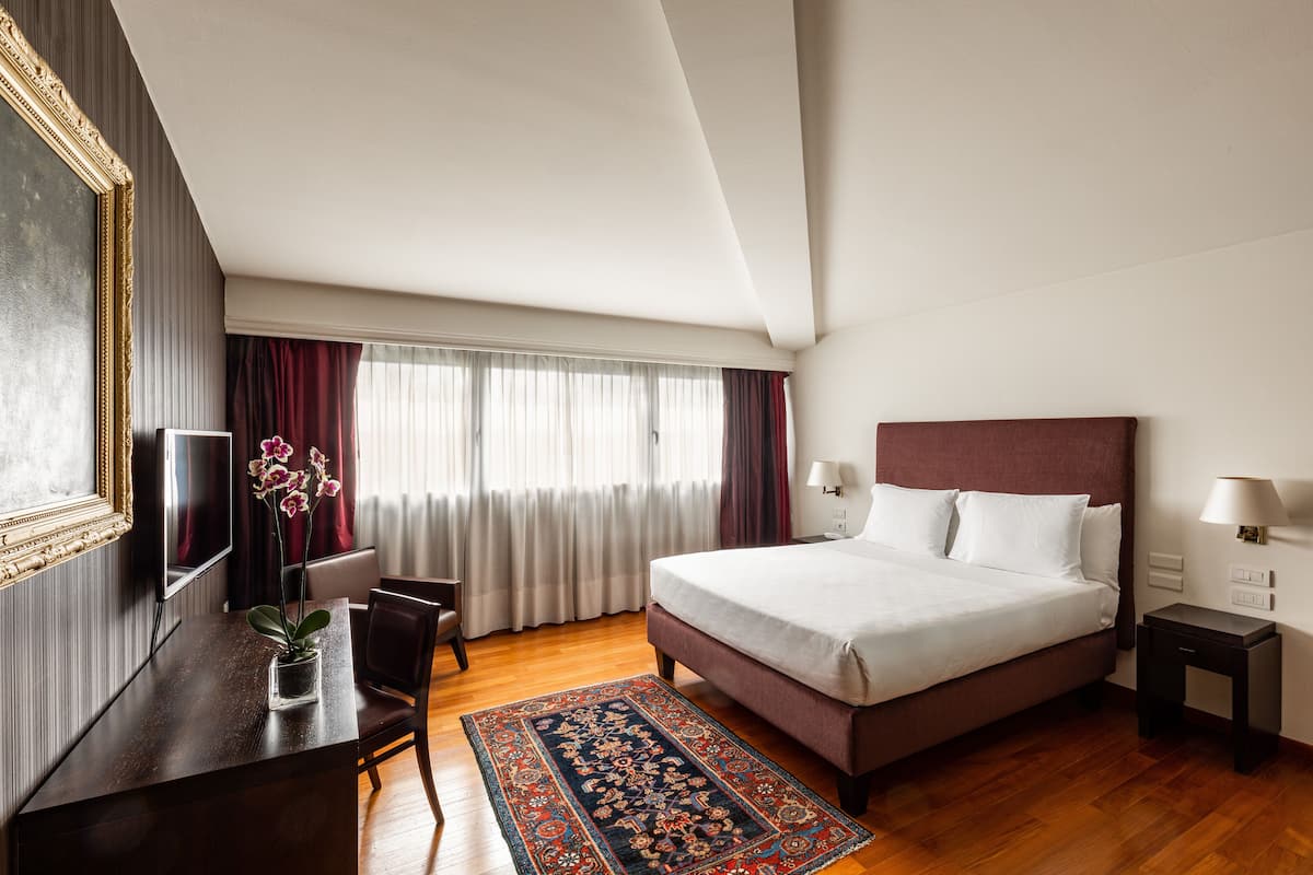 Suite | Edredón, minibar, caja de seguridad en la habitación y escritorio