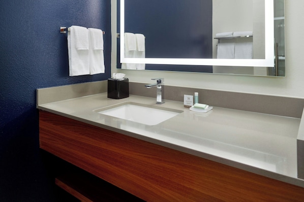 A bathroom with a white sink, a mirror, and a towel rack. - Fairfield Inn & Suites Charleston North/University Area (North Charleston)