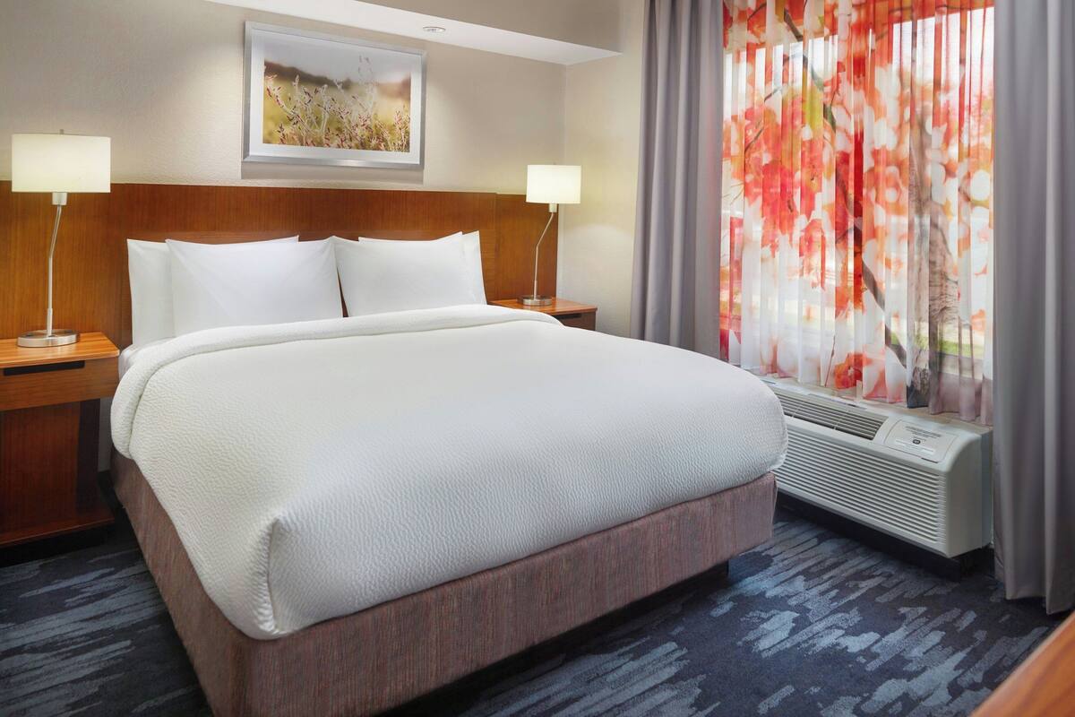 Premium bedding, desk, laptop workspace, blackout drapes