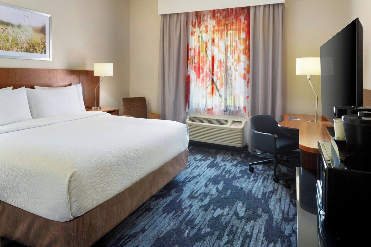Premium bedding, desk, laptop workspace, blackout drapes