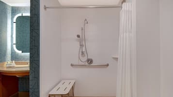 A bathroom with a shower, a toilet, and a sink.