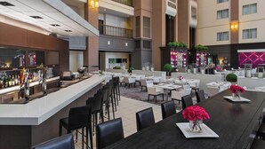 A modern hotel lobby with a bar area, dining tables, and a spacious seating arrangement. - Le Meridien Dallas by the Galleria (Dallas)