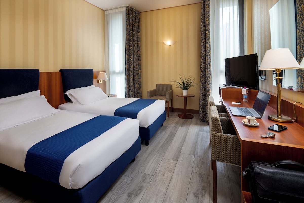 Classic Triple Room | Minibar, in-room safe, desk, blackout drapes