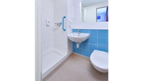 A bathroom with a shower, a sink, and a toilet. - Travelodge Sedgefield (Stockton-on-Tees)