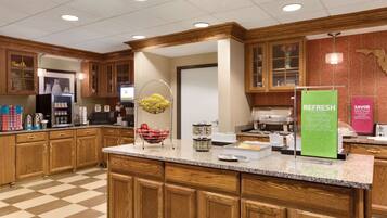 A well-equipped kitchen with wooden cabinets, granite countertops, and various appliances.