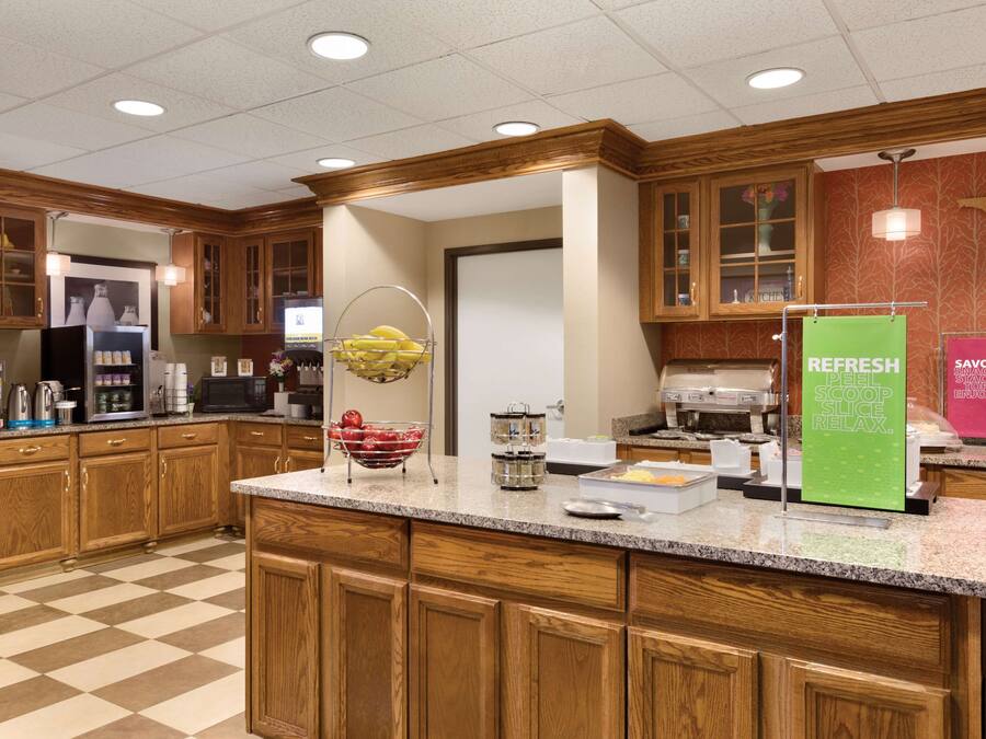 A well-equipped kitchen with wooden cabinets, granite countertops, and various appliances.