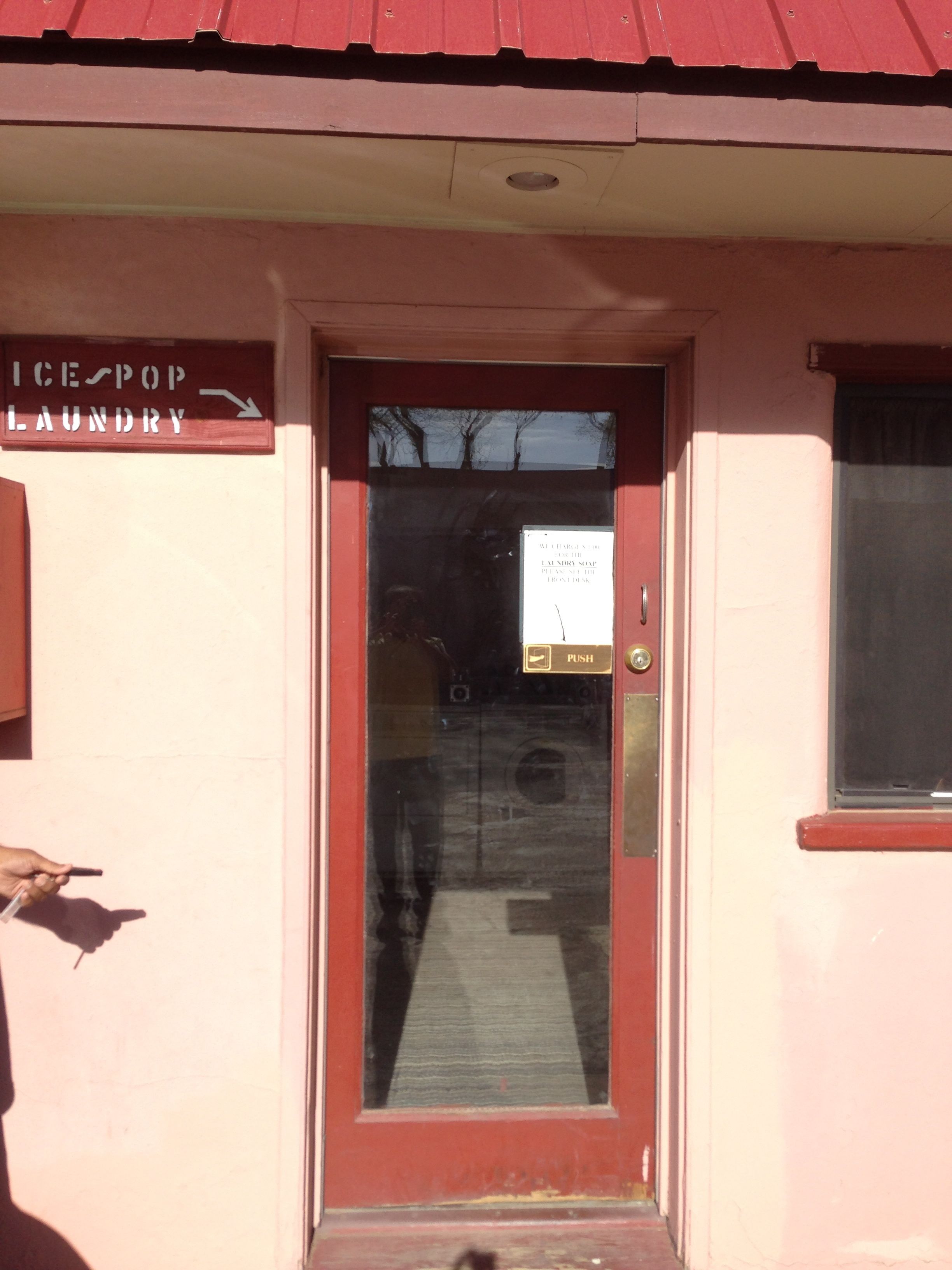 A building entrance with a sign for 'Ice Pop Laundry'.