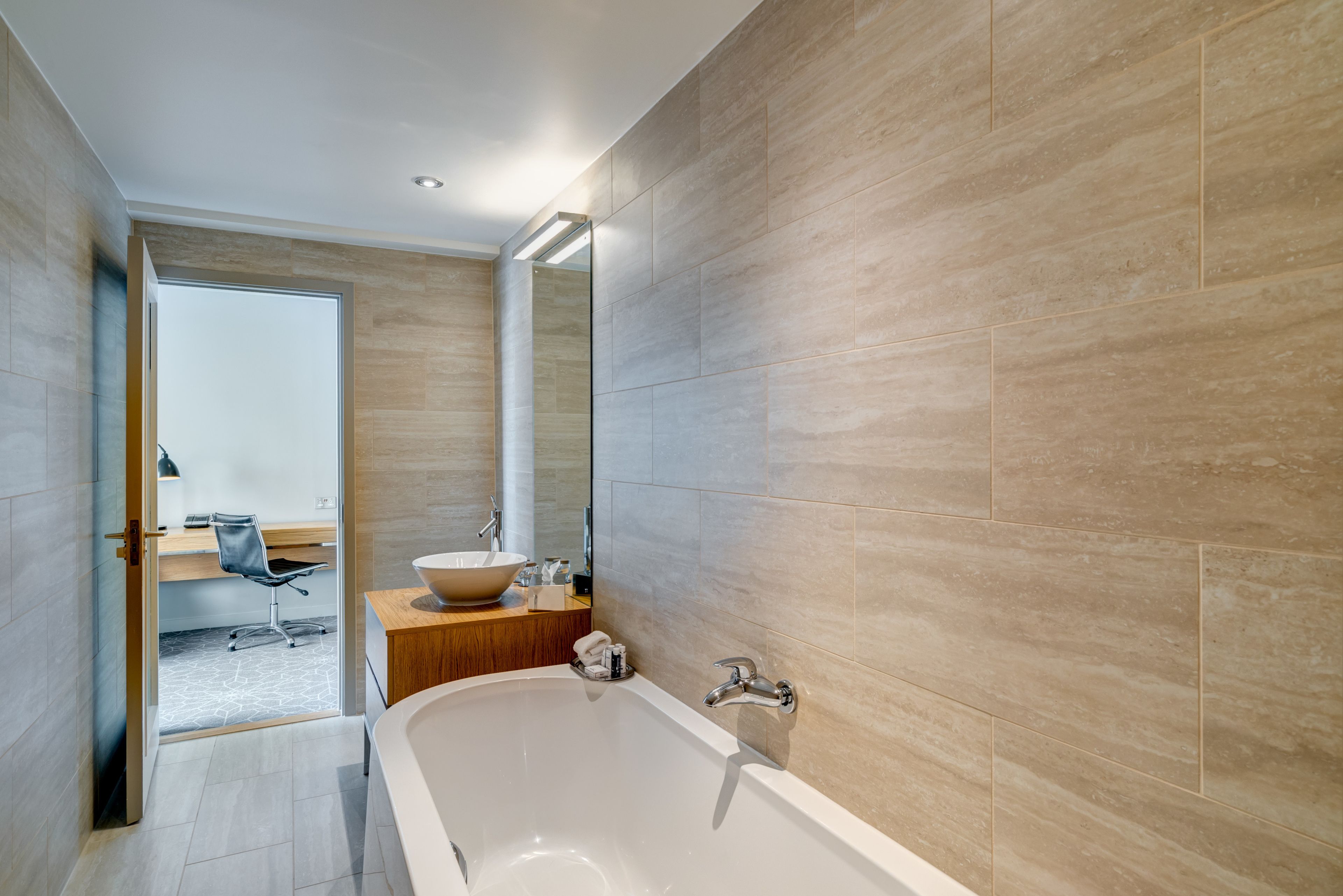 junior suite | bathroom | separate bathtub and shower, eco-friendly toiletries, hair dryer, towels