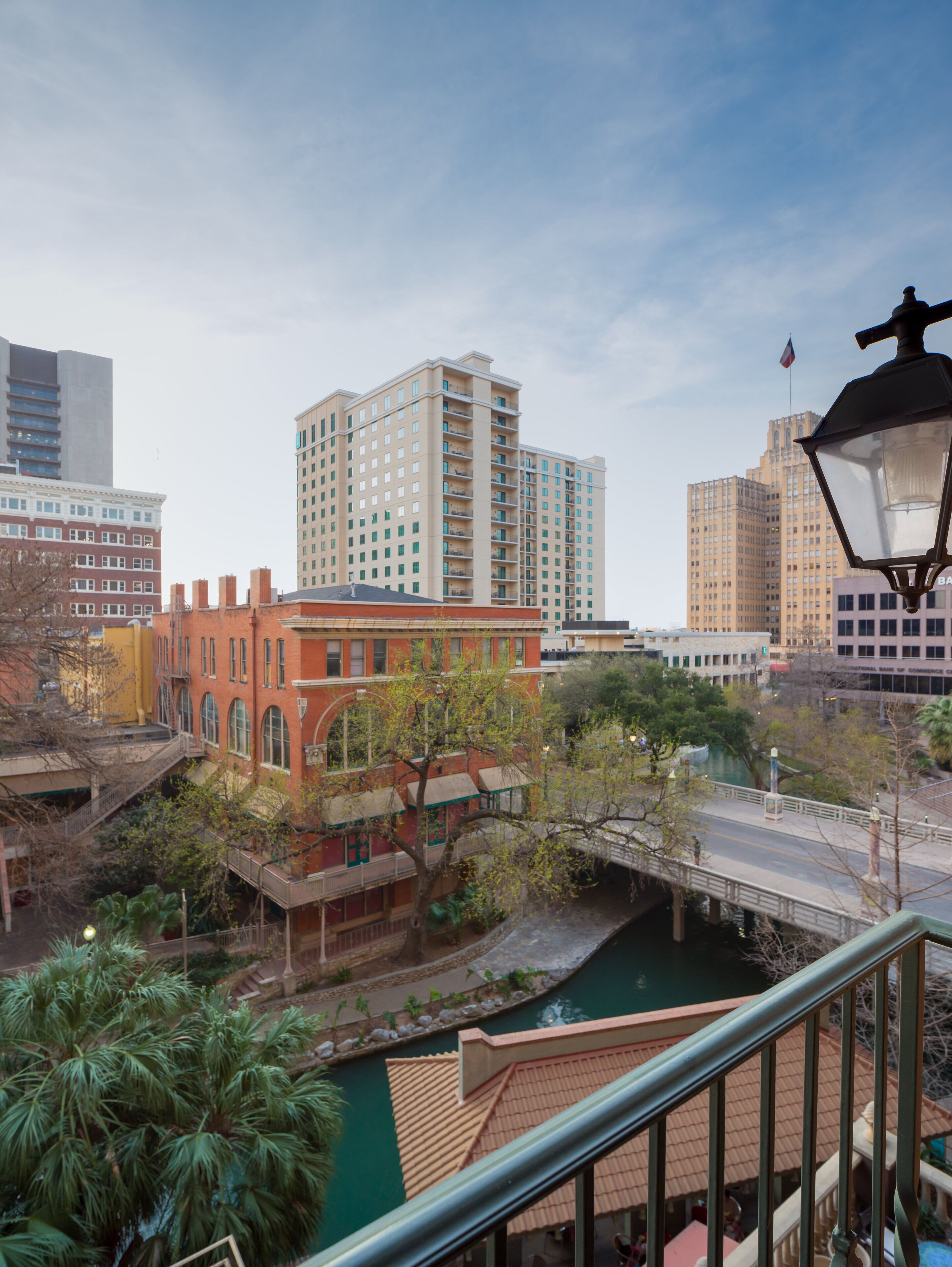 A cityscape with a mix of modern and historic buildings, a bridge, and a river.