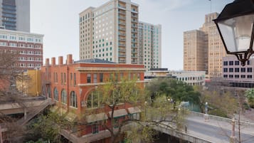 A cityscape with a mix of modern and historic buildings, a bridge, and a river.