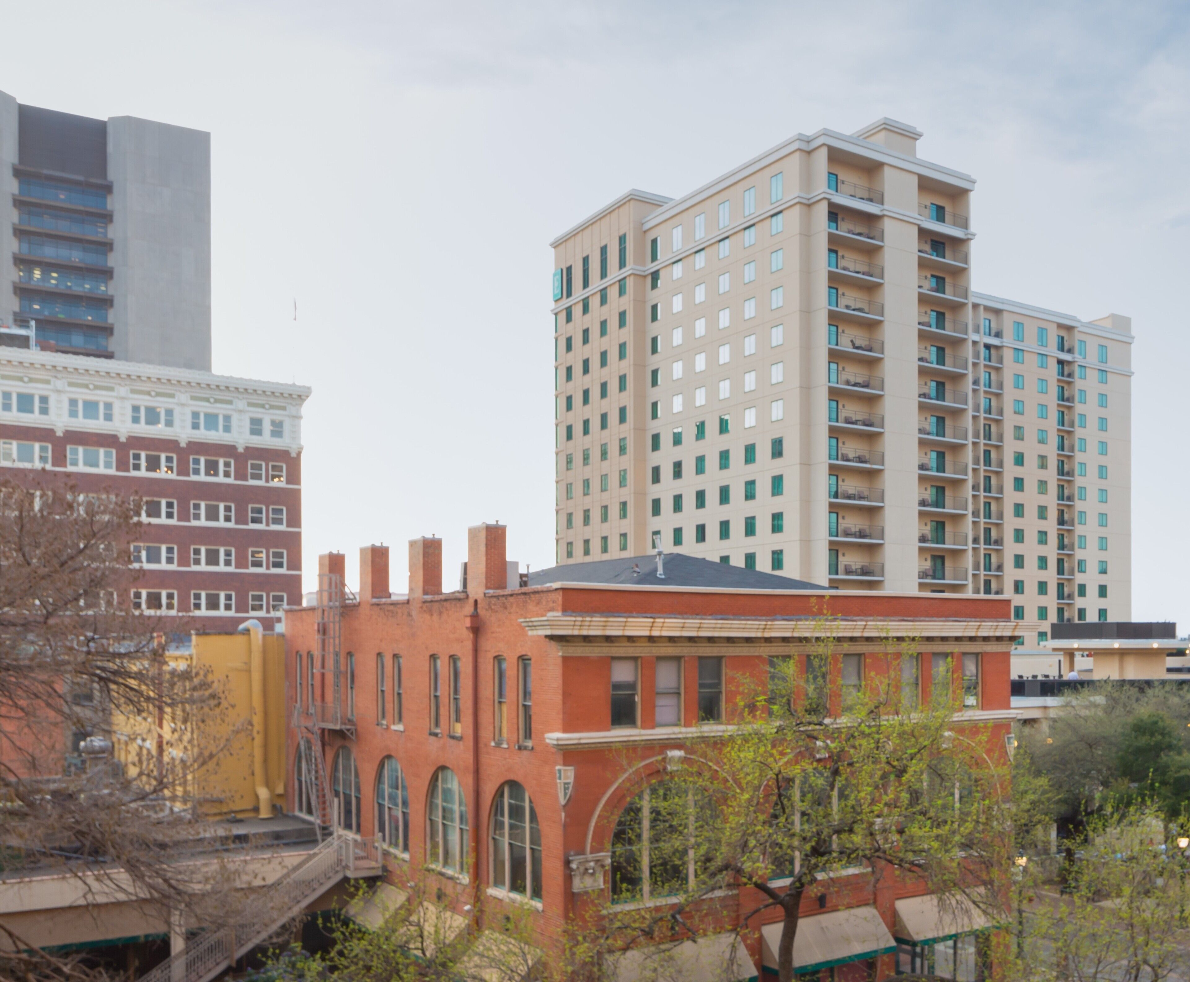 A multi-story building with a flat roof and a series of balconies.