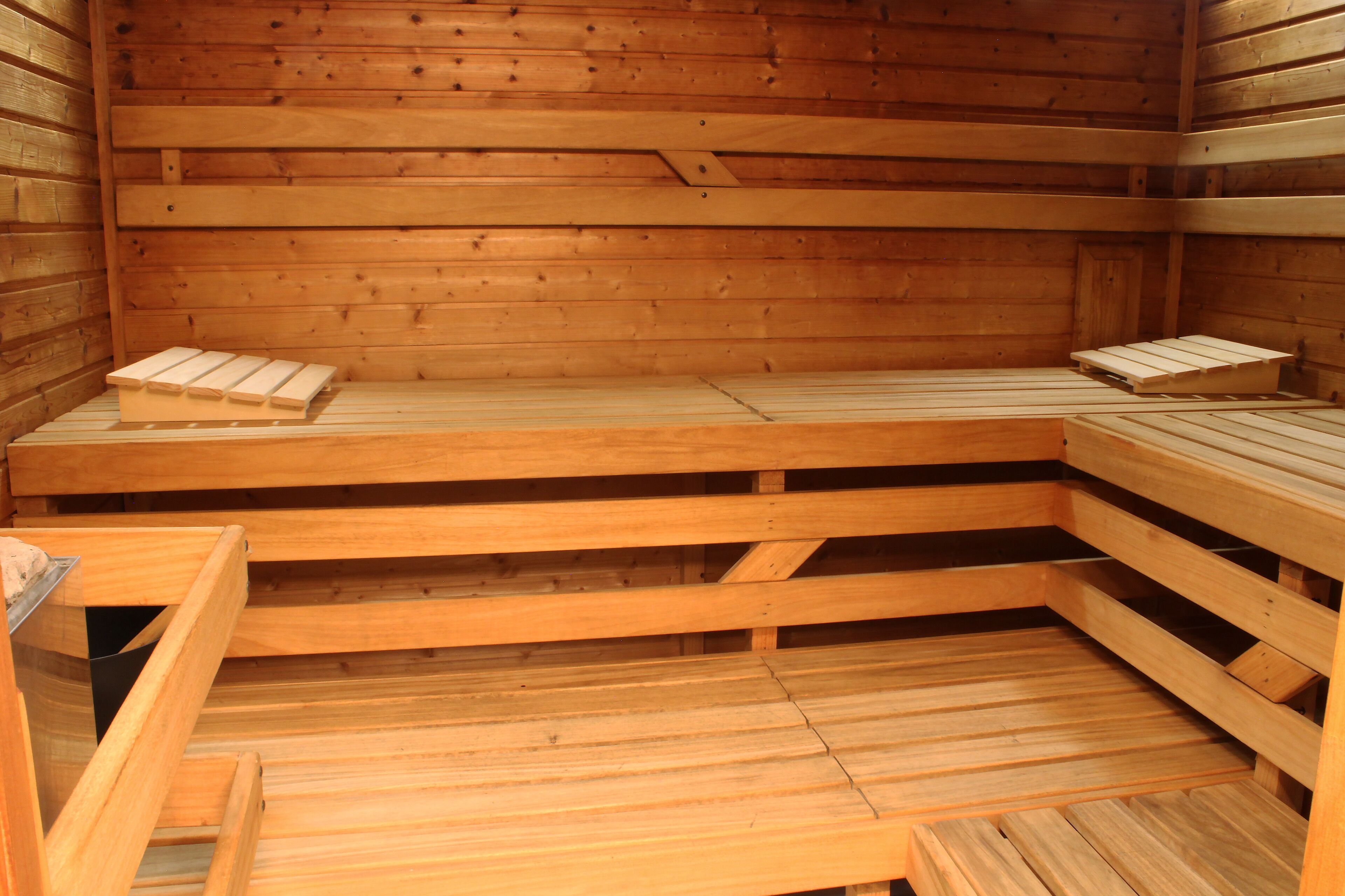 A sauna with wooden benches and a bench seat.