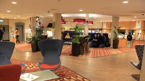 A hotel lobby with seating areas, a reception desk, and a bar. - Cedar Court Wakefield (Wakefield)