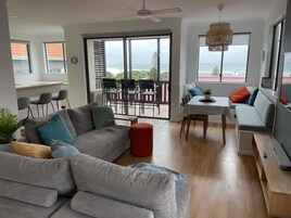 Apartment, 2 Bedrooms, Ocean View | Living area | 68-cm flat-screen TV with digital channels, TV