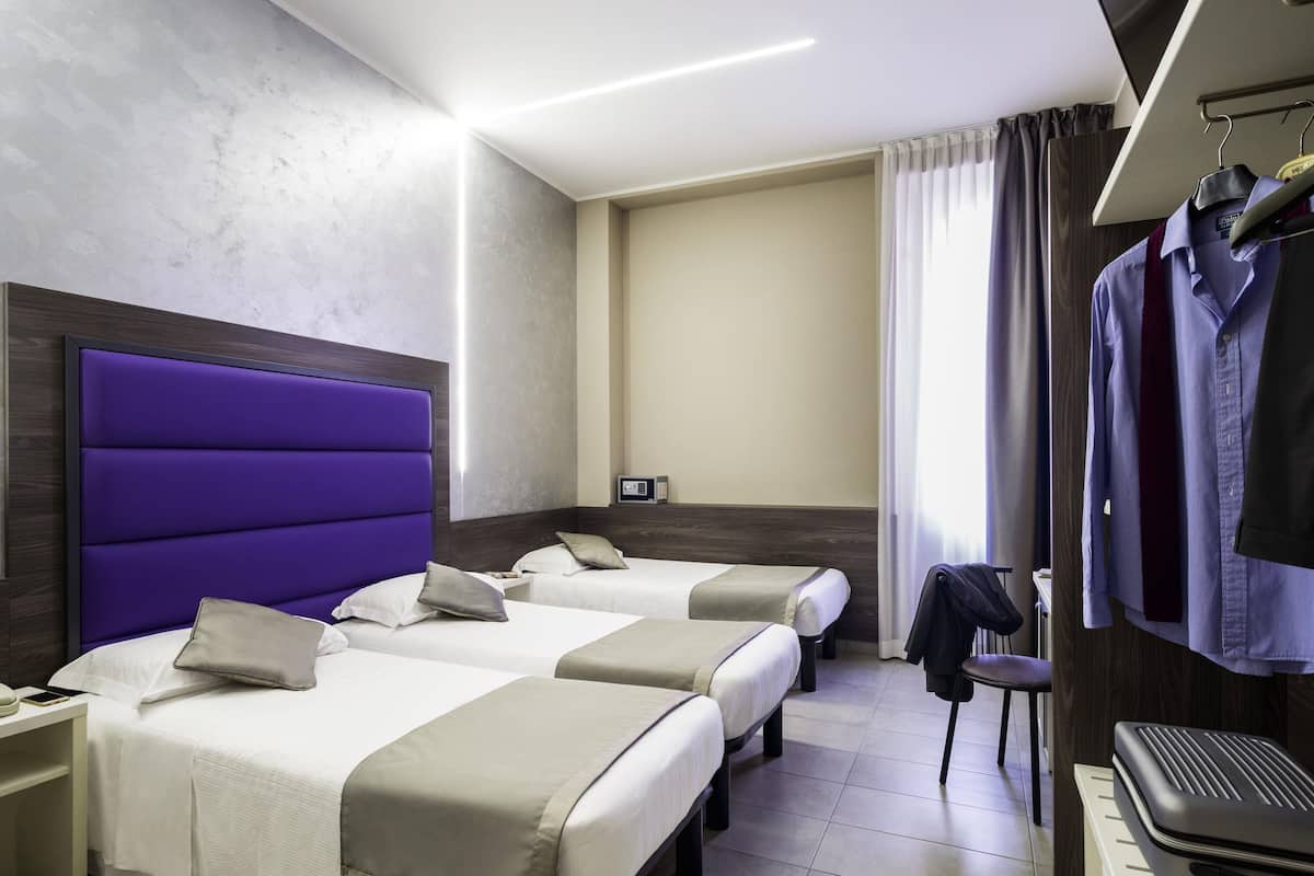 Driepersoonskamer, meerdere bedden | Luxe beddengoed, donzen dekbedden, een minibar, een kluis op de kamer