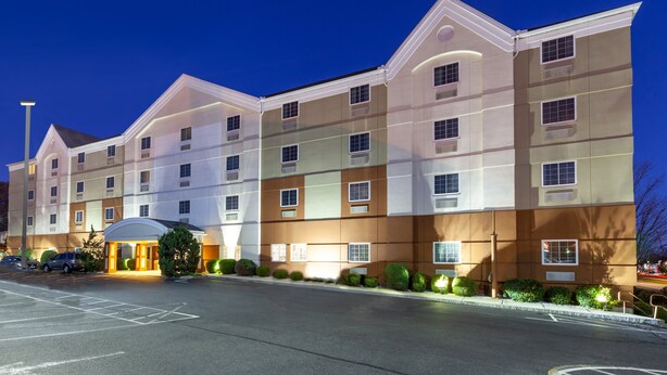 A multi-story hotel with a modern facade, large windows, and a well-lit entrance.