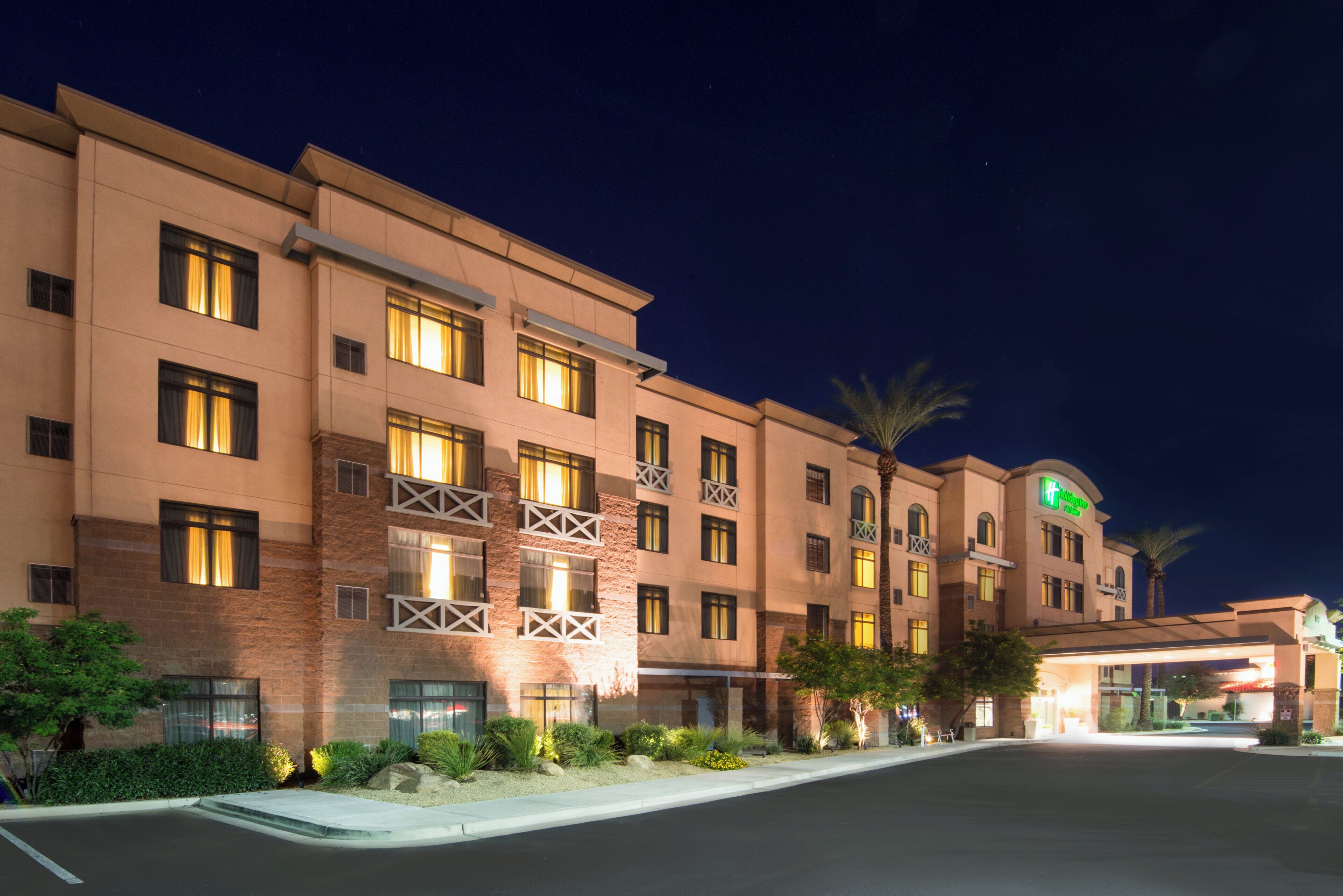 A multi-story hotel with a flat facade, large windows, and a sign indicating it is a Holiday Inn Express.