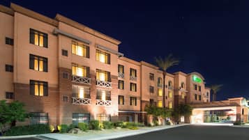 A multi-story hotel with a flat facade, large windows, and a sign indicating it is a Holiday Inn Express.