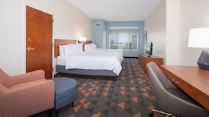 A hotel room with a bed, a desk, a chair, and a TV. - Holiday Inn & Suites Goodyear - West Phoenix Area by IHG (Goodyear)