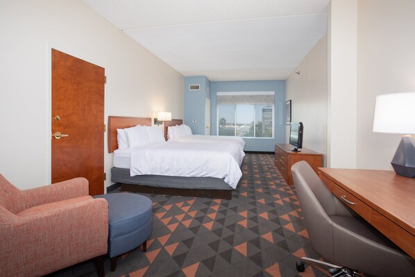 A hotel room with a bed, a desk, a chair, and a TV. - Holiday Inn & Suites Goodyear - West Phoenix Area by IHG (Goodyear)