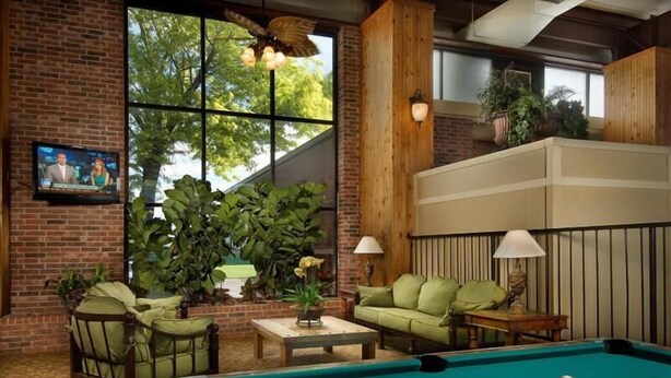 A cozy indoor setting with a pool table, comfortable seating, and a television.