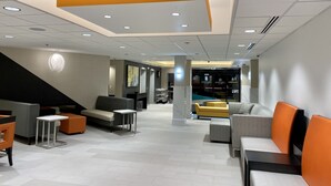 A modern lobby with seating areas, a staircase, and a reception desk. - La Quinta Inn by Wyndham Lynnwood (Lynnwood)