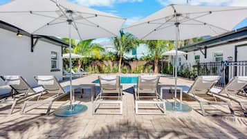 Outdoor pool, a heated pool, open 8:00 AM to 8:00 PM, pool umbrellas