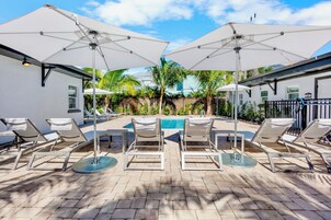 Outdoor pool, a heated pool, open 8:00 AM to 8:00 PM, pool umbrellas