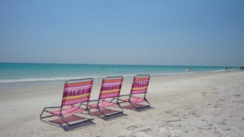 Beach nearby, white sand, sun loungers, beach towels