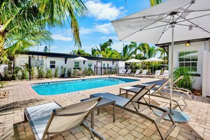 Outdoor pool, a heated pool, open 8:00 AM to 8:00 PM, pool umbrellas