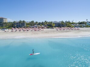 On the beach, white sand, sun-loungers, beach umbrellas
