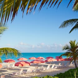 On the beach, white sand, sun loungers, beach umbrellas