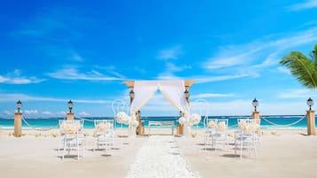 On the beach, white sand, beach towels, beach massages