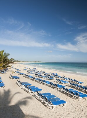 On the beach, white sand, beach towels, beach massages