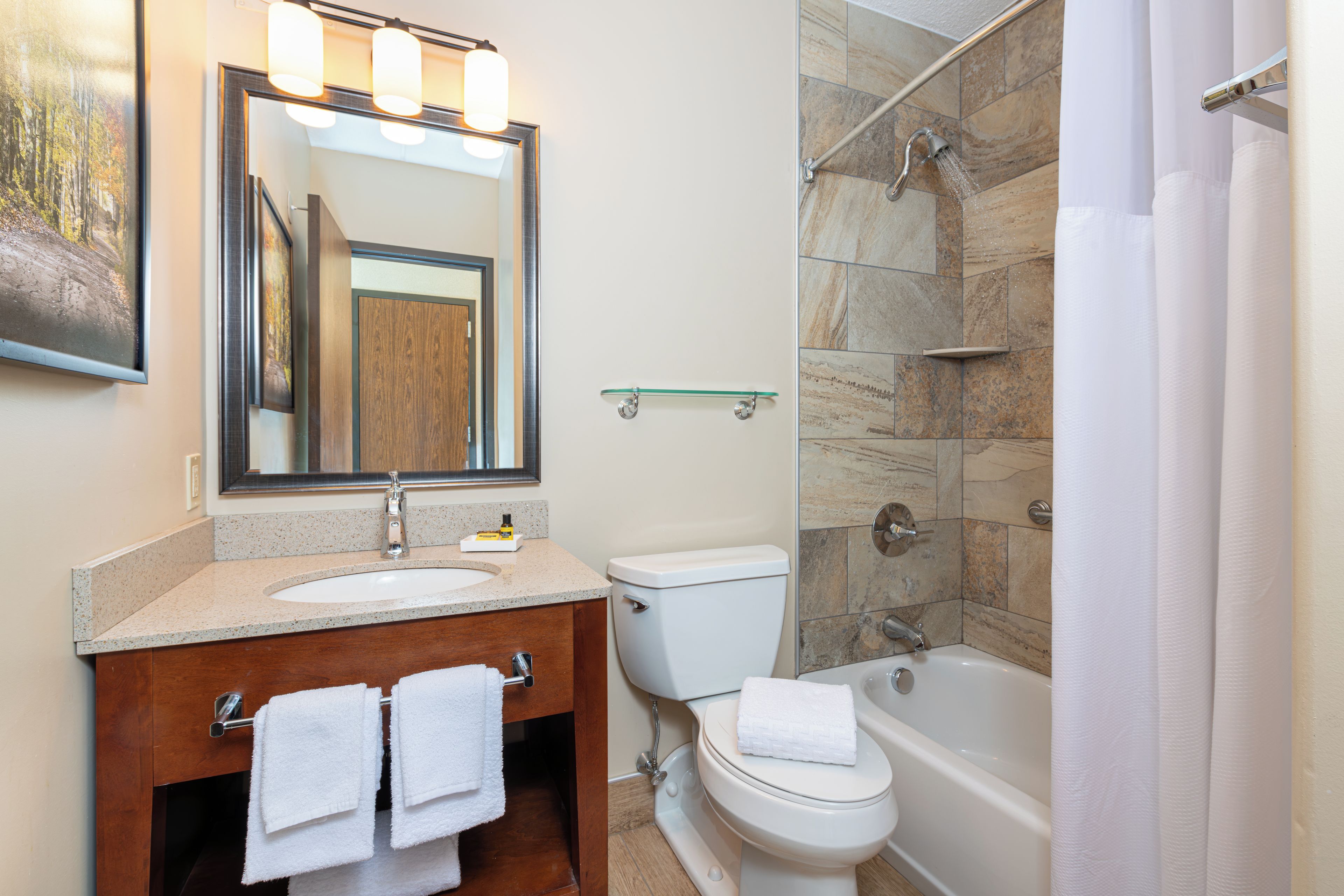 A bathroom with a sink, toilet, bathtub, and shower.