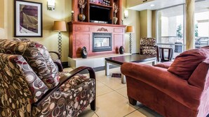 A spacious living area with a fireplace, comfortable seating, and a view of the outdoors.