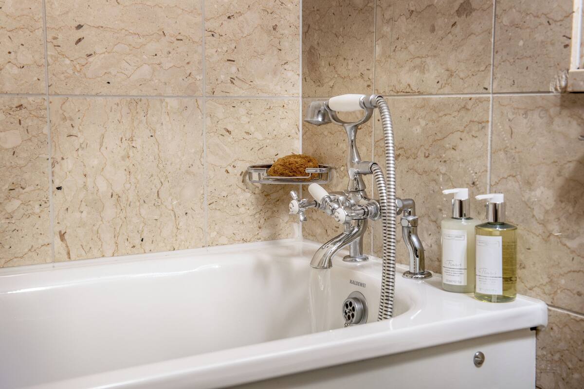 junior suite | bathroom | separate bathtub and shower, free toiletries, hair dryer, bathrobes