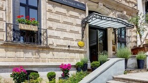 A stone building with a sign reading "Galata Antique Hotel". There are steps leading to the entrance, and potted plants are visible. - Galata Antique Hotel - Special Class (Istanbul)