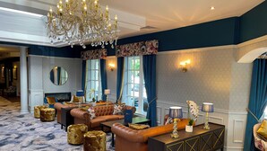 A luxurious lobby with a grand chandelier, plush seating, and a decorative console table. - Ardboyne Hotel (Navan)