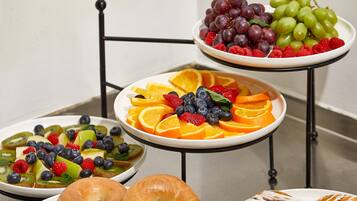 A fruit platter with grapes, strawberries, blueberries, and kiwi slices.