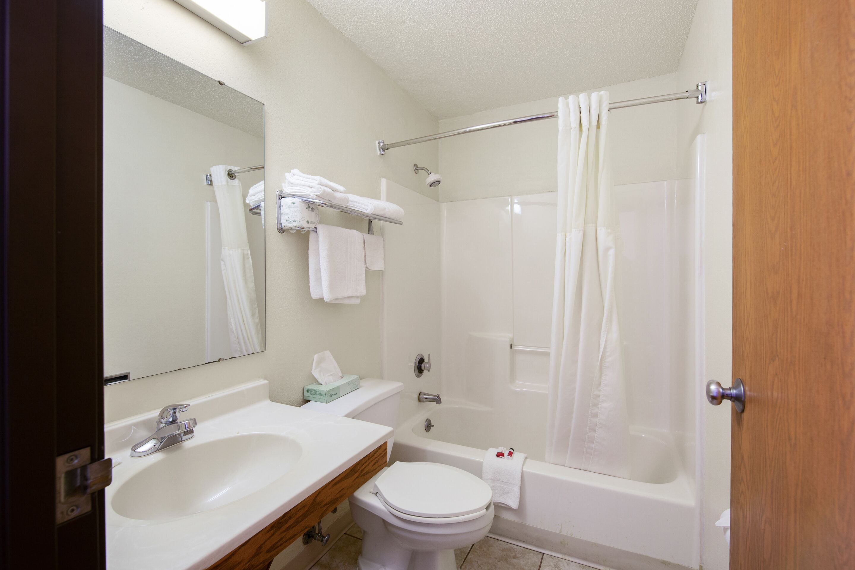 A bathroom with a sink, toilet, and bathtub.